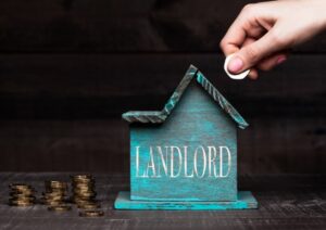 Image of a house shaped money box with landlord written on it