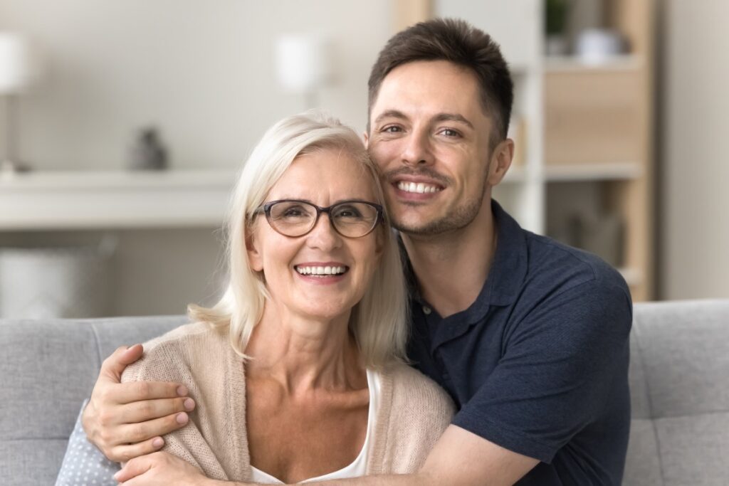 Mother and son hugging after she helped him with a guarantor mortagage