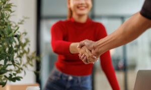 Man and woman shake hands at a mortgage application interview/meeting